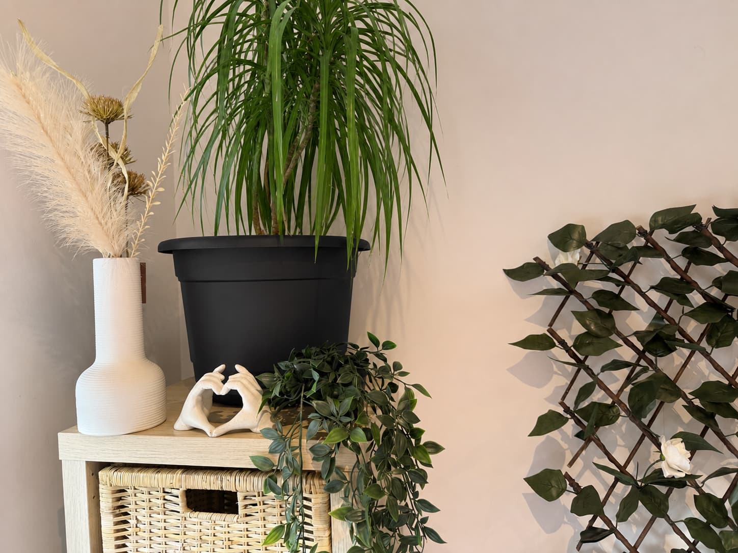 Styled corner with vase, ceramic hands and greenery