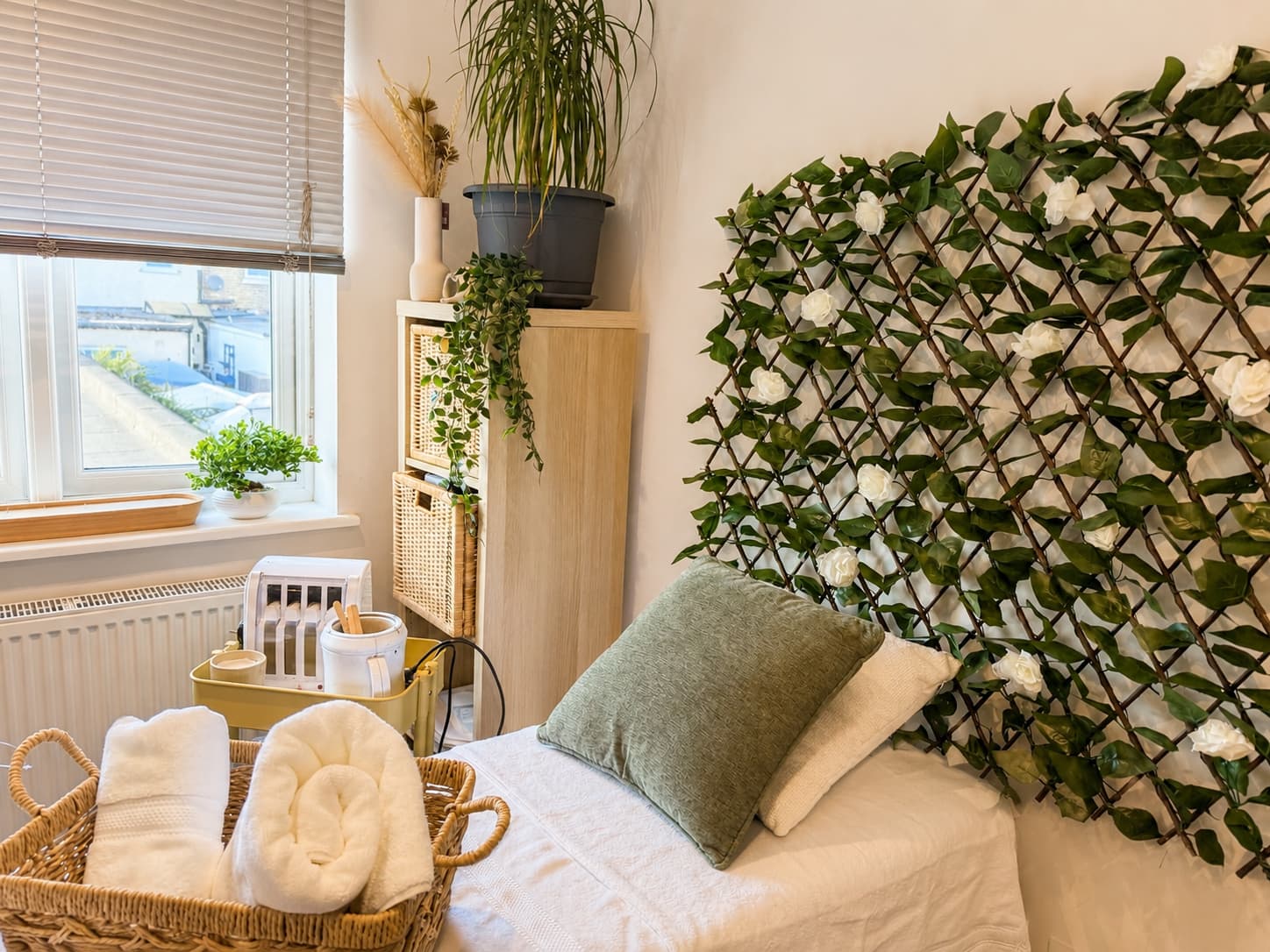 Waxing station beside the window with fresh towels and plants